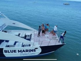 A lively group enjoys a fun day aboard the Blue Marine catamaran in Punta Cana, engaging in activities and soaking up the sun on the water.
