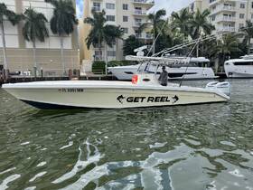 A sleek speedboat named 'Get Reel' docked in a marina, showcasing its stylish design and ready for adventure on the water.