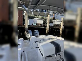 Interior view of a well-equipped boat featuring comfortable seating and a helm area, perfect for a day on the water.