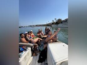 A lively group enjoys a fun day on the water, celebrating together on a boat — perfect for summer outings and memorable gatherings.