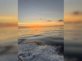 A stunning sunset over calm waters, reflecting vibrant colors — a perfect backdrop for evening boat trips and serene moments on the water.