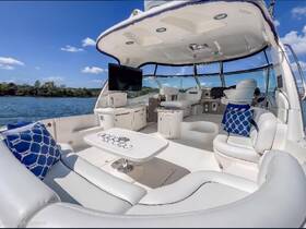 A stylish interior view of a boat's cabin featuring comfortable seating and a helm, perfect for relaxing while cruising on the water.