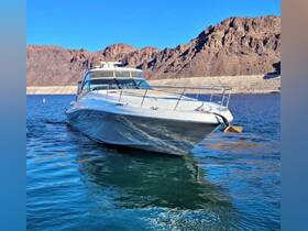 A stunning view of a sleek yacht cruising through clear waters, set against a backdrop of rugged mountains — perfect for luxury boating adventures.