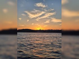 A stunning sunset over the coastline, casting vibrant colors across the water — a perfect backdrop for evening boat trips and romantic getaways.