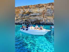 A cheerful group enjoys a sunny day on a boat in Malta's crystal-clear waters, perfect for a fun-filled adventure or celebration.