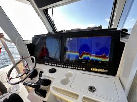 A detailed view of the helm and console inside an Everglades boat, showcasing advanced navigation and control features — perfect for experienced boaters.