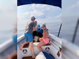 A lively group enjoys a moment on the boat, showcasing the fun and camaraderie of a day out on the ocean.