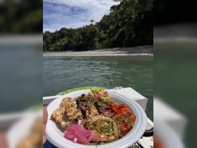 A delicious plate of grilled meats and vegetables served on a boat, perfect for enjoying a gourmet meal while cruising through scenic waters.