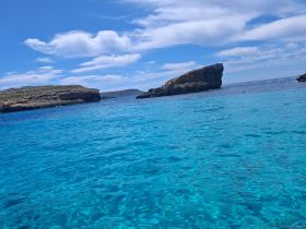 A stunning view of crystal-clear turquoise waters and rocky coastlines, perfect for showcasing the natural beauty of the destination.