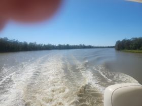 A view of a river with wake trails, but the image is unclear and lacks identifiable features.