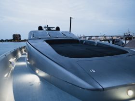 A sleek yacht captured from the back, showcasing its elegant design as it rests at the dock, perfect for luxury boating experiences.