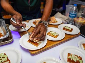 A chef prepares delicious food on a boat, showcasing a variety of plated dishes — perfect for onboard catering experiences.
