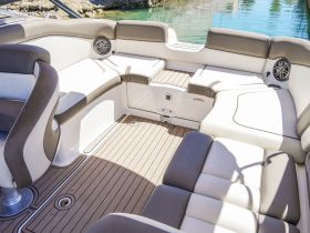 Interior view of a stylish boat seating area, featuring comfortable cushions and a sleek design, perfect for relaxing on the water.