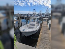 A sleek speedboat docked at the marina, showcasing its clean lines and inviting design, perfect for a day on the water.