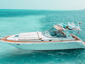 A stunning aerial view of a sleek speedboat cruising through crystal-clear turquoise waters, perfect for luxury outings and water adventures.
