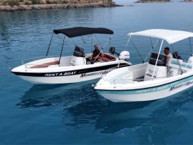 Two friends enjoy a day on the water in rental boats, showcasing the perfect setting for a fun boating adventure.