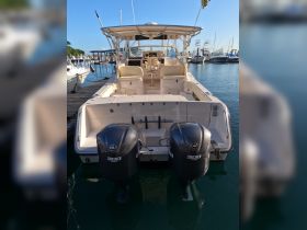 A sleek speedboat docked at the marina, showcasing its powerful twin Yamaha 300 engines — perfect for thrilling adventures on the water.