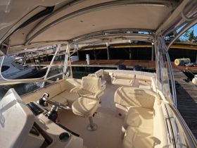 Interior view of a Grady-White boat's helm and seating area, showcasing a spacious and comfortable design ideal for fishing or leisure outings.