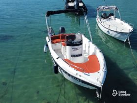 A sleek speedboat docked in clear turquoise waters, perfect for a day of adventure on the water. Ideal for rentals and exploring coastal destinations.