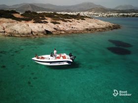 A couple enjoys a serene moment on a boat in crystal-clear waters, surrounded by stunning island scenery — perfect for a relaxing day on the water.