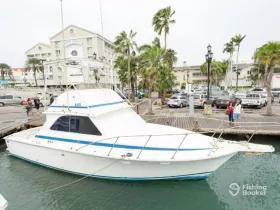 A sleek yacht docked at the marina, showcasing its elegant design while people stroll nearby, perfect for a day of boating adventures.