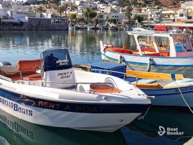 A picturesque view of rental boats docked in a serene harbor, perfect for fishing trips and exploring the coastline.