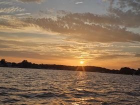 A stunning sunset over tranquil waters, capturing the beauty of nature — perfect for evening boat rides and scenic views.