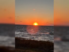 A stunning sunset over the ocean, casting vibrant colors across the sky and water — a perfect backdrop for evening boat trips or romantic getaways.