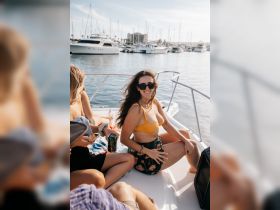 A group of friends enjoys a sunny day on a boat, capturing the essence of fun and relaxation on the water.
