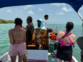 A group of friends enjoys a fishing trip on a boat, showcasing camaraderie and adventure on the water.