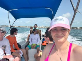 A lively group enjoys a boat ride, capturing the essence of fun and adventure on the water. Perfect for showcasing memorable experiences with friends.