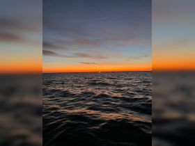 A stunning sunset over the ocean, capturing the serene beauty of the water and sky — perfect for tranquil evening boat rides.
