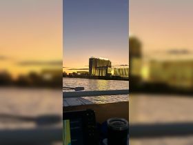 A picturesque sunset view over the water, showcasing a vibrant city skyline — perfect for evening boat cruises and scenic experiences.