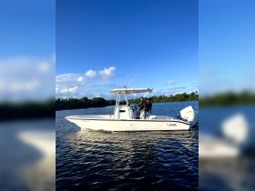 Two individuals enjoy a scenic boat ride on a sunny day, showcasing the perfect blend of adventure and relaxation on the water.