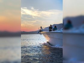 A group enjoys a scenic sunset cruise on a boat, capturing the essence of relaxation and camaraderie on the water.