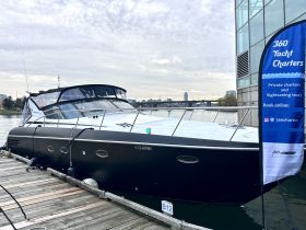 A sleek yacht docked at the marina, showcasing its elegant design and available for private charters and sightseeing tours.