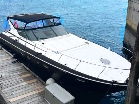 A sleek yacht docked at the marina, showcasing its elegant design and spacious deck, perfect for luxury outings on the water.