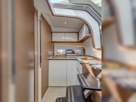 A modern boat kitchen featuring sleek cabinetry and a well-designed layout, perfect for preparing meals while on the water.