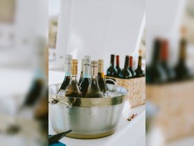 A stylish display of chilled wines and champagne in a metal bucket, perfect for onboard celebrations and gatherings.