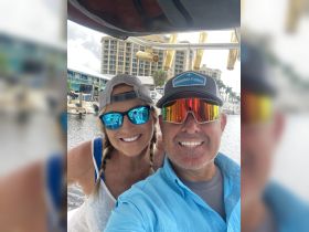 A cheerful couple takes a selfie while enjoying a day on the water, showcasing the fun and excitement of boating adventures.