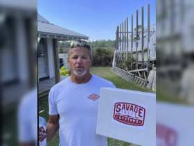 A man holding a box of oysters stands outdoors, possibly promoting a seafood business. The background suggests a coastal setting, but details are ambiguous.
