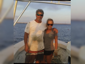 A couple poses together on a boat, enjoying a beautiful sunset — perfect for fishing trips and romantic outings on the water.