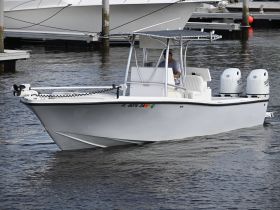 A sleek speedboat navigates the water, showcasing its modern design and powerful engines, perfect for thrilling adventures on the water.