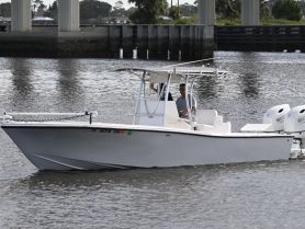 A boat navigates through calm waters with a captain at the helm, showcasing the thrill of a day on the water.
