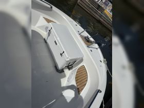 A well-equipped boat deck featuring a YETI cooler, perfect for keeping drinks and snacks cool during your boating adventures.