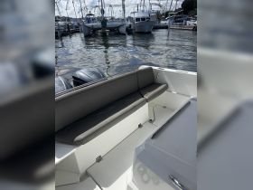 A cozy seating area inside a boat, showcasing the comfortable design perfect for relaxing while on the water.