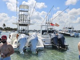 A group of friends enjoys a day of fishing on a well-equipped boat, showcasing the excitement of a fun-filled day on the water.
