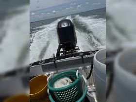 An overview of fishing gear and equipment on a boat, showcasing buckets and nets ready for a day of fishing on the water.