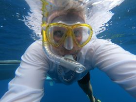 A snorkeler captures an underwater selfie, showcasing the vibrant marine environment — perfect for adventure seekers and ocean enthusiasts.