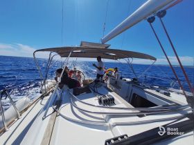 A lively group enjoys a sailing adventure on a sunny day, capturing the essence of ocean exploration and camaraderie aboard the yacht.